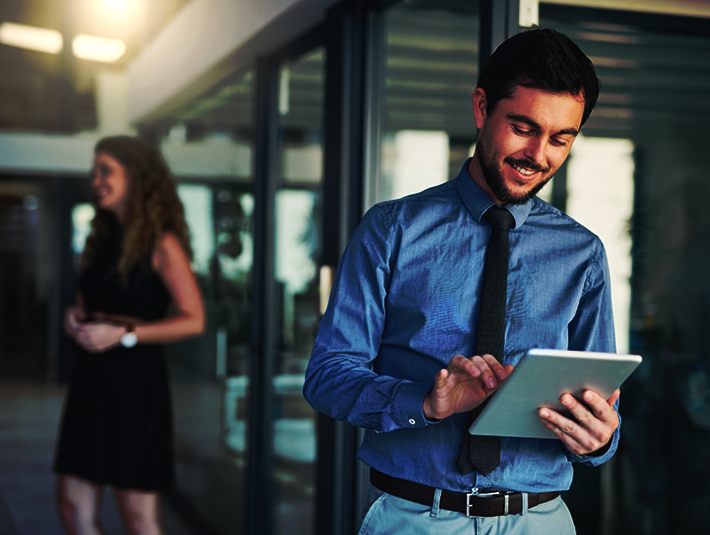a man looking at his tablet